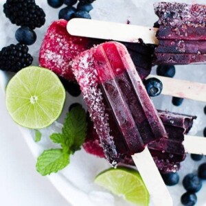 An image of a berry popsicle with sugar on one edge.
