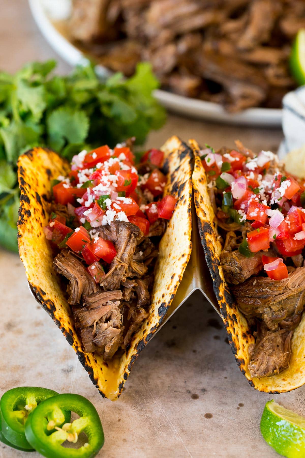 Chipotle barbacoa tacos topped with fresh salsa and cheese.