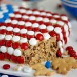 An image of a cake decorated like an American flag and filled with cookie dough.