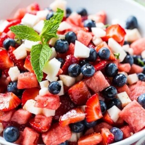 An image of a fruit salad with strawberries, blueberries and jicama.
