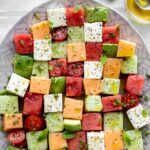 An image of square cut melon arranged for a salad.