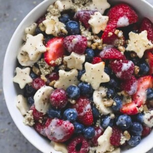 An image of fruit salad with quinoa and red, white and blue fruits.