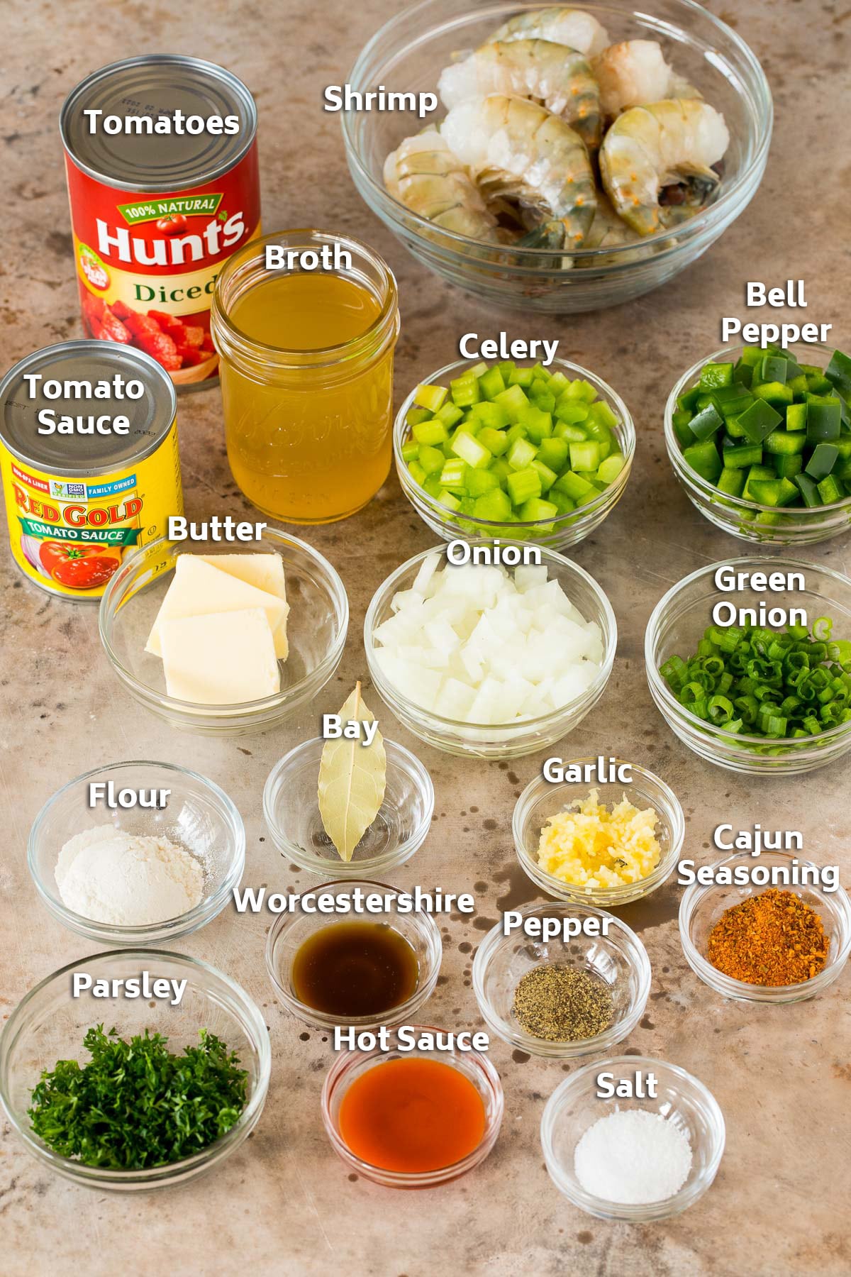 Bowls of ingredients including shrimp, vegetables, broth, herbs and seasonings.
