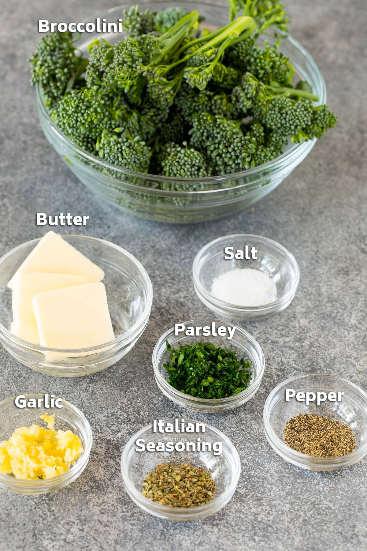 Bowls of ingredients including baby broccoli, butter and seasonings.