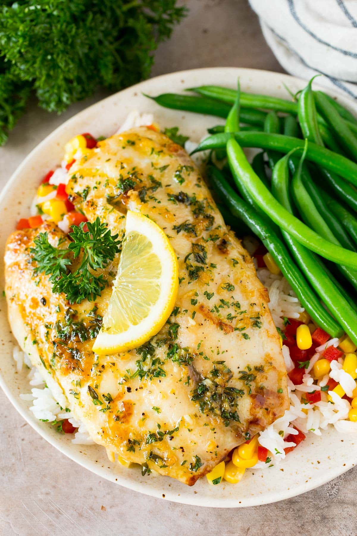 Baked tilapia served with rice and green beans.