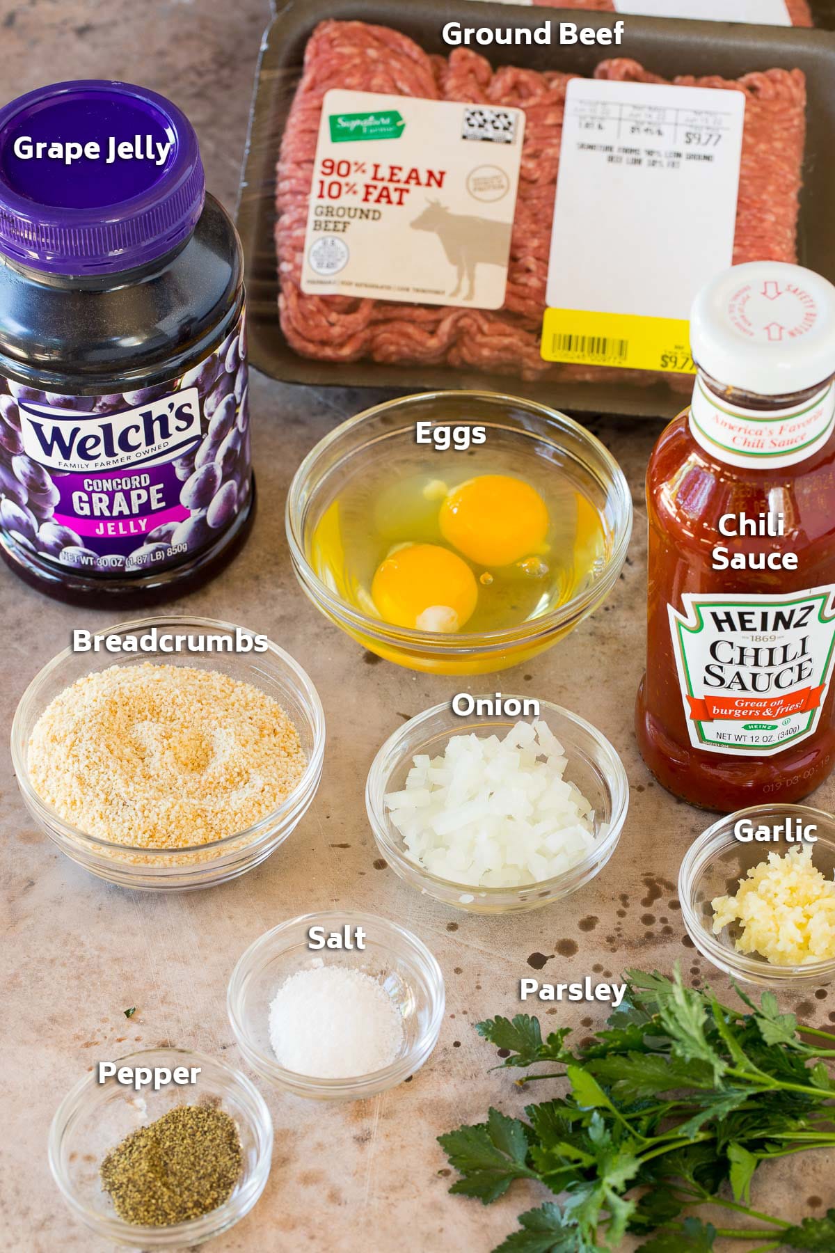 Ingredients including ground beef, eggs, breadcrumbs, seasonings and grape jelly.