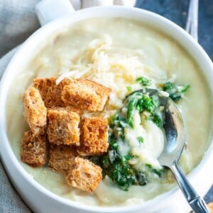 An image of a bowl of pesto potato soup.