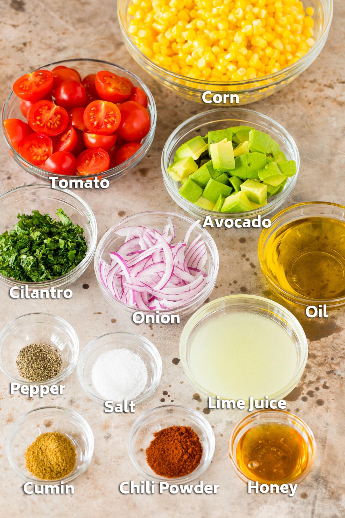 Bowls of ingredients including vegetables, cilantro and seasonings.