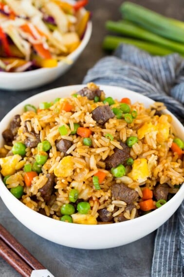 A bowl of beef fried rice topped with green onions.