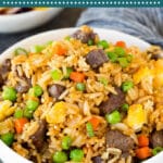 This beef fried rice is cubes of marinated steak cooked with eggs, vegetables and rice in a savory sauce.