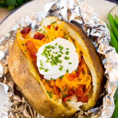 Crock pot baked potatoes topped with sour cream and bacon.