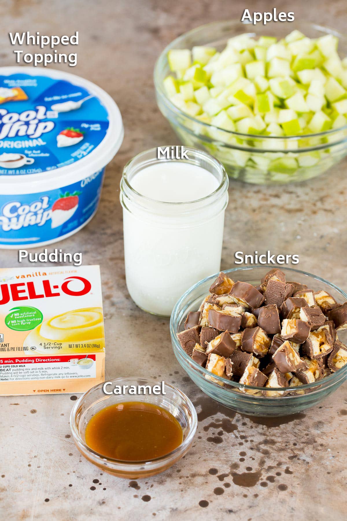 Ingredients including apples, milk, pudding mix, candy bars and caramel.