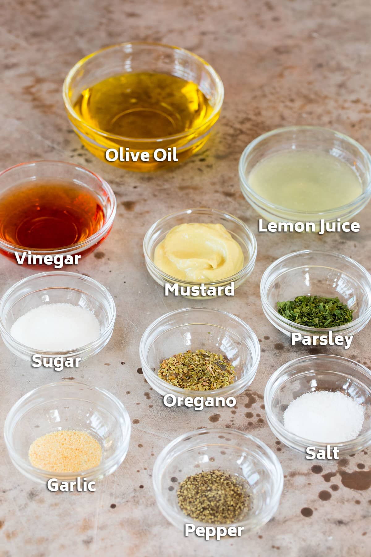 Bowls of ingredients to make salad dressing.