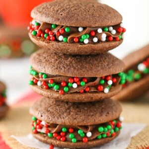 An image of three stacked double chocolate sandwich cookies.