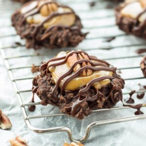 An image of no bake turtle cookies on a wire cooling rack.