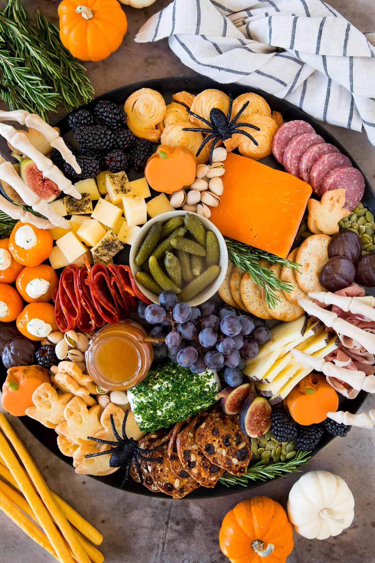 A Halloween charcuterie board filled with meats, cheeses, crackers and Halloween sweets.