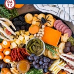 This Halloween charcuterie board is an assortment of cheeses, meats, crackers, fruit and Halloween themed sweets, all combined to make the perfect impressive party display.