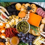 This Halloween charcuterie board is an assortment of cheeses, meats, crackers, fruit and Halloween themed sweets, all combined to make the perfect impressive party display.