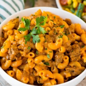 A bowl of homemade hamburger helper topped with parsley.