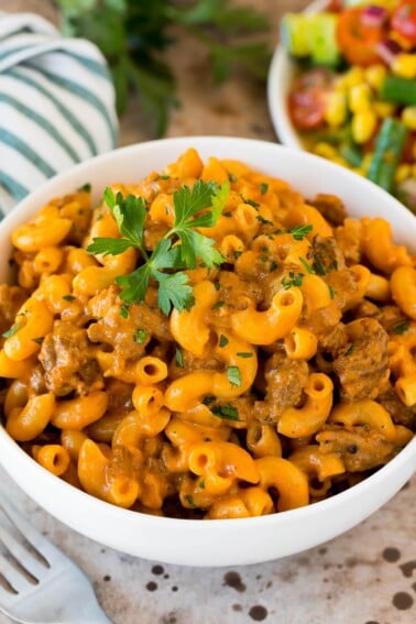 A bowl of homemade hamburger helper topped with parsley.