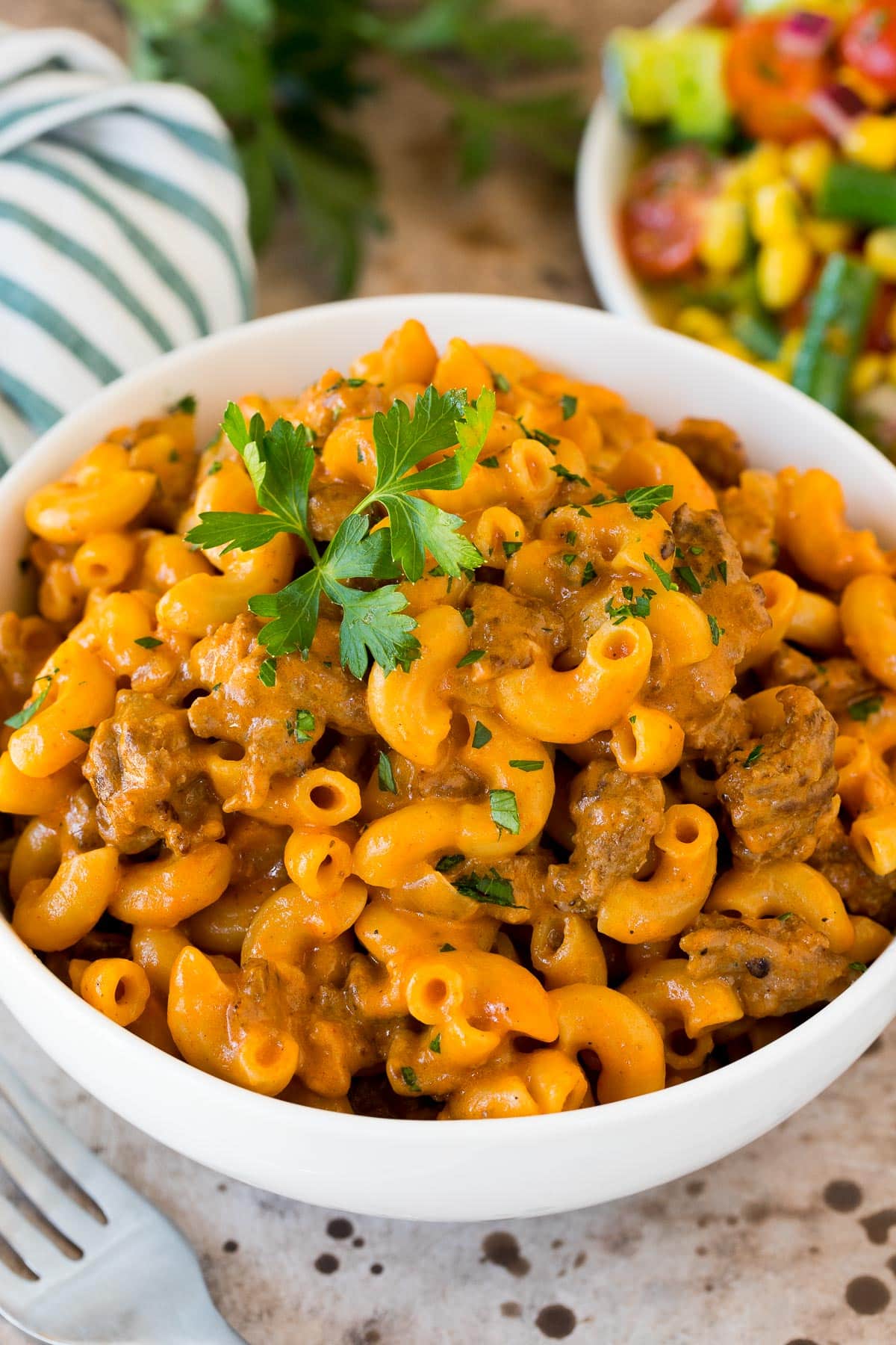 A bowl of homemade hamburger helper topped with parsley.