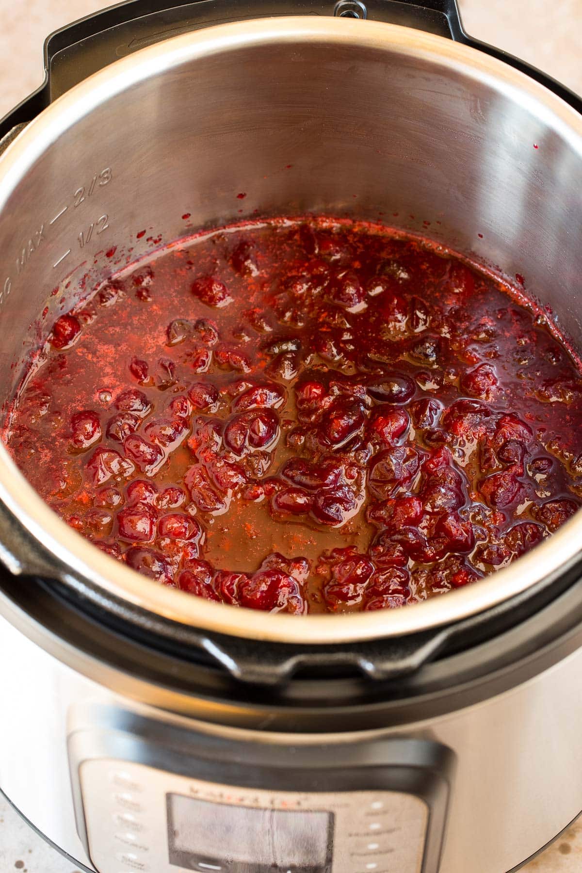 Cranberry sauce inside of a pressure cooker.