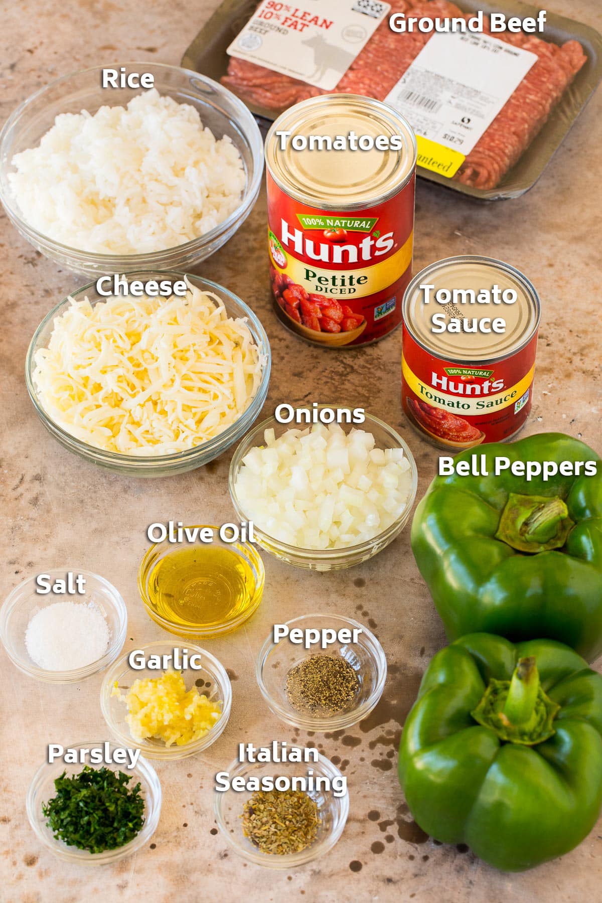 Ingredients including green peppers, rice, meat, cheese and seasonings.
