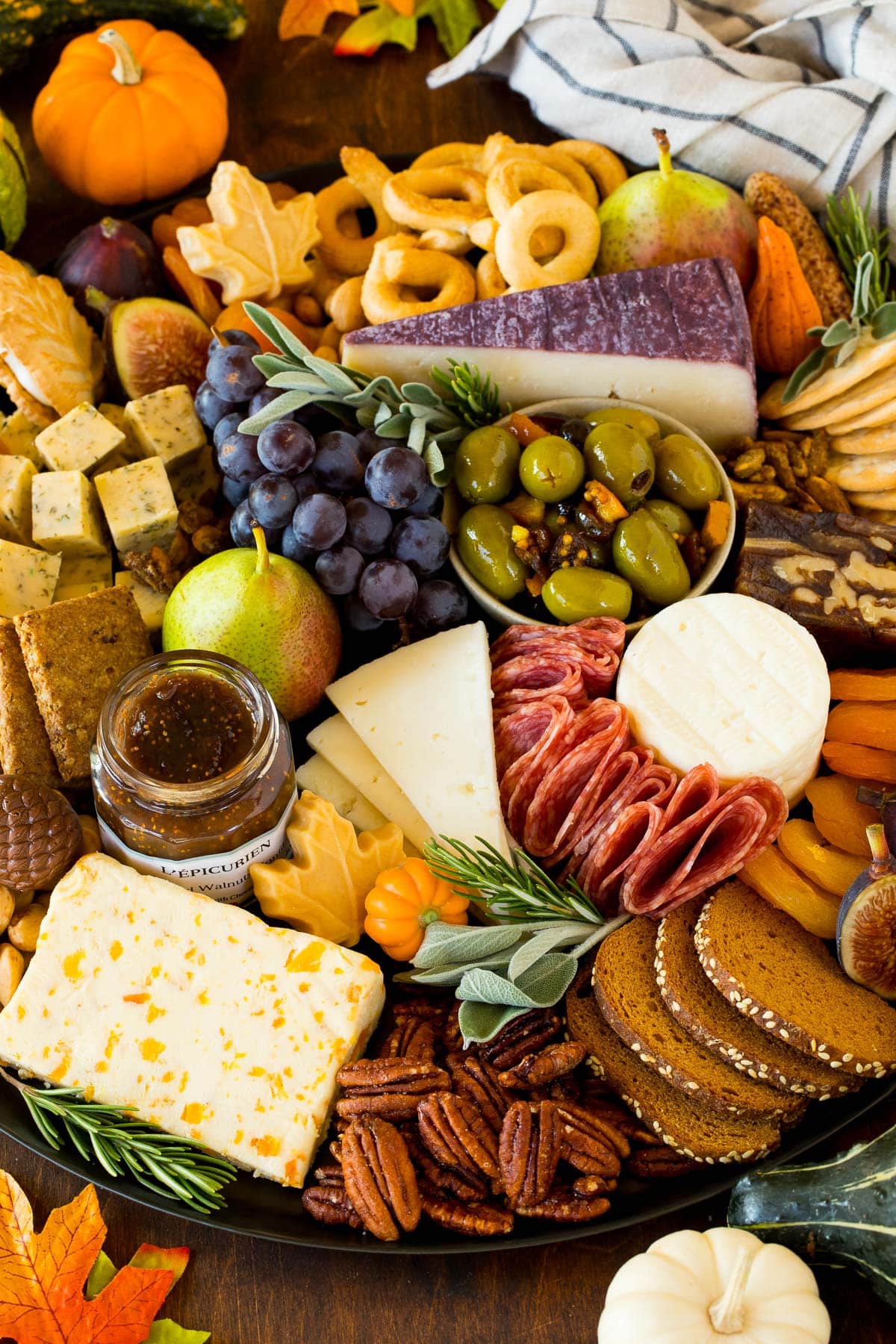 A Thanksgiving charcuterie board with meats, cheeses and fall fruit.