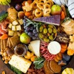 A Thanksgiving charcuterie board made with meats, cheeses, crackers, fruit and fall themed sweets.