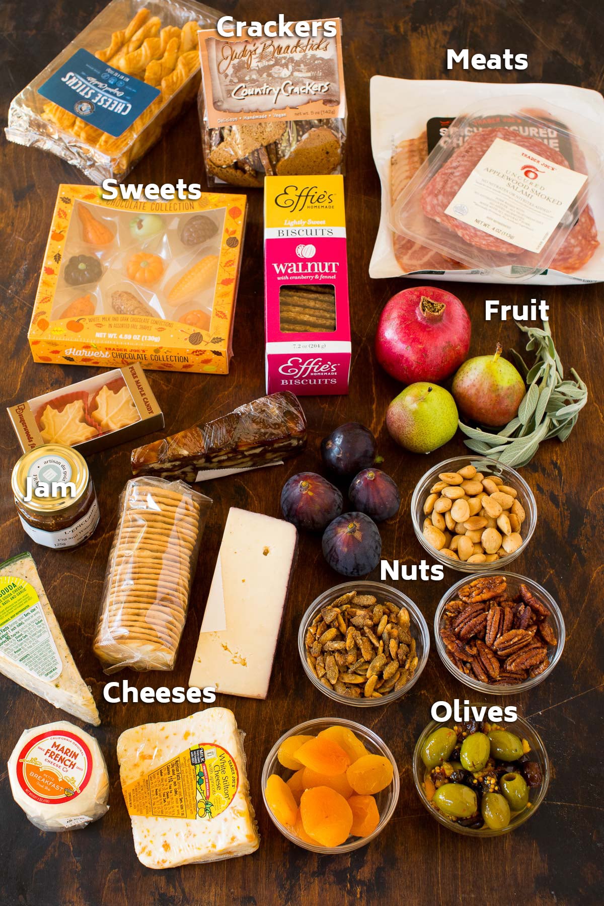 Packages of ingredients including crackers, nuts, olives and cheeses.