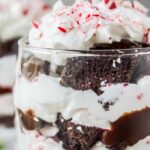 An image of a candy cane brownie trifle in a glass.