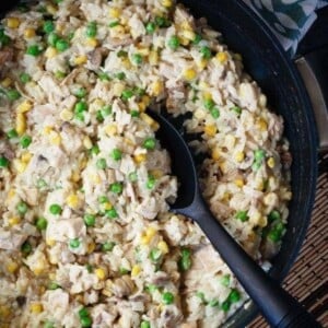 An image of a pot of creamy turkey and rice with a spoon in it.