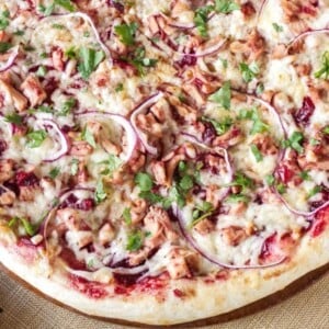 An image of a pizza with turkey and barbecue sauce toppings.