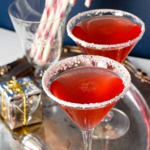 A picture of two candy cane cocktails on a silver tray.