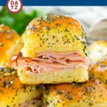 These ham and cheese sliders are Hawaiian rolls topped with ham, swiss cheese and an onion poppy seed butter, then baked to perfection.