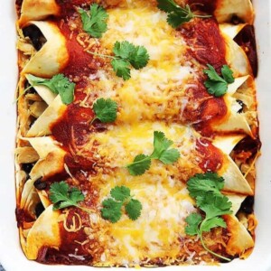 An image of turkey enchiladas side by side in a baking dish.