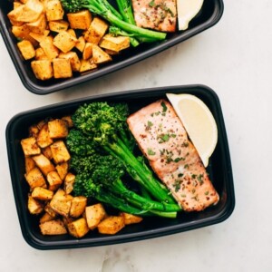 An image of roasted salmon with sweet potatoes and broccolini.