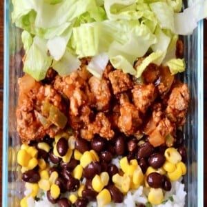 An image of a taco bowl with turkey, rice, lettuce and beans.