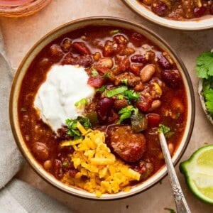 An image of a bowl of slow cooker chili with sausage.
