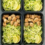 An image of several containers of lemon garlic butter chicken with zucchini noodles.