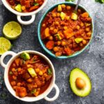 An image of three bowls of slow cooker chickpea chili on a table.