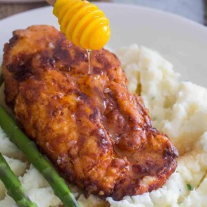 An image of truffle honey chicken on mashed potatoes.