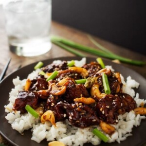 An image of spicy cashew chicken over white rice.