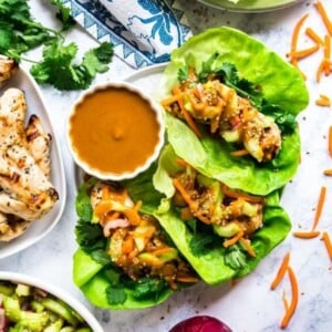 An image of three Thai lettuce wraps with a peanut sauce.
