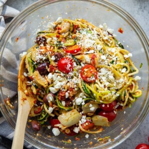 An image of a bowl of Mediterranean zucchini noodle salad.