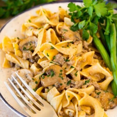 A plate of ground beef stroganoff served with green beans.