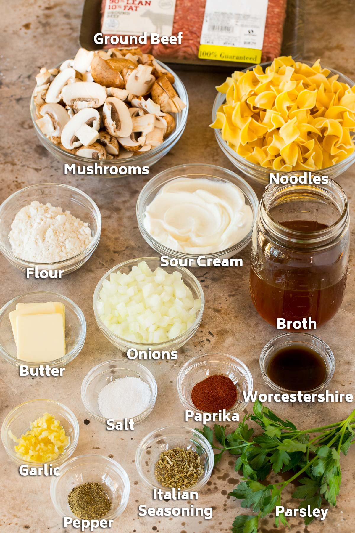 Bowls of ingredients including vegetables, broth, herbs and seasonings.