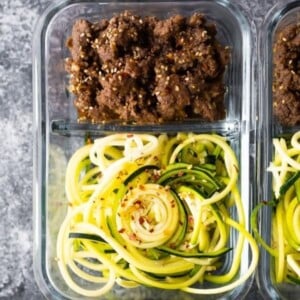 An image of a container of sesame ginger zucchini noodles.