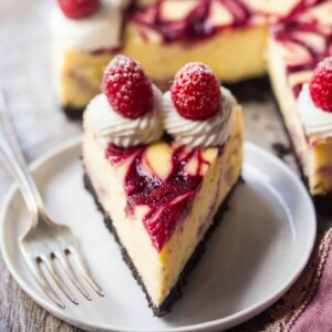 An image of a slice of white chocolate raspberry cheesecake.