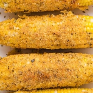 An image of a few ears of deep fried corn on the cob.